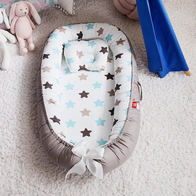 Réducteur de lit bébé portatif
